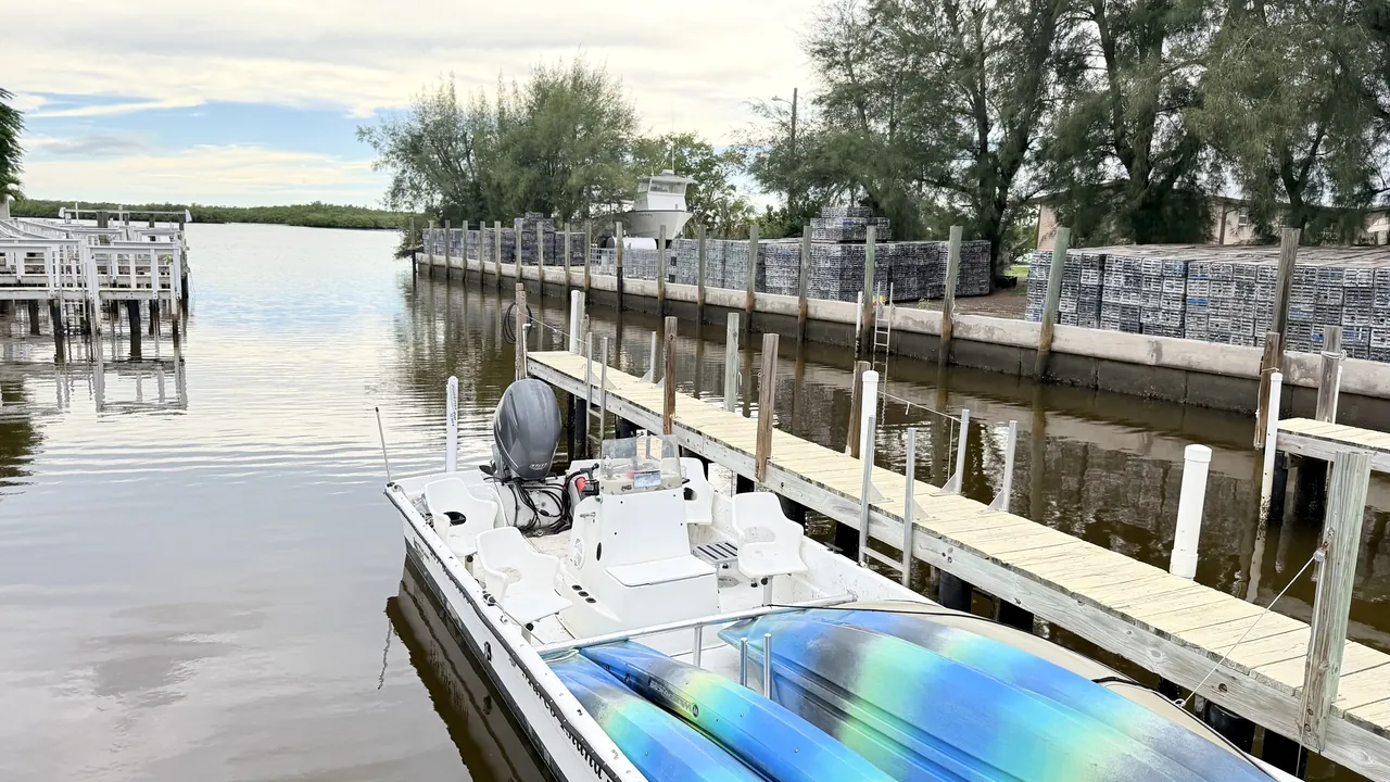 A skiff tied up in its slip on the marina basin